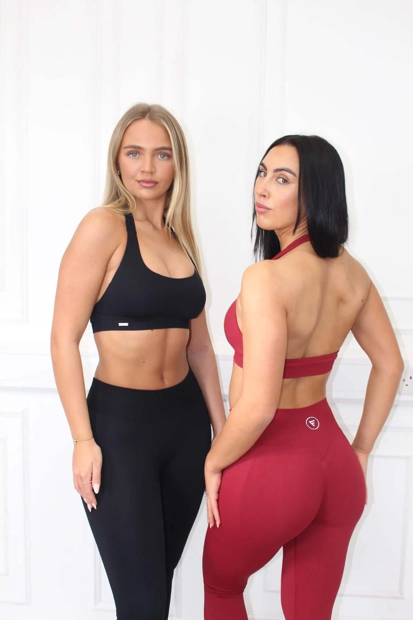 Two women model The Empower Edge Collection - Scrunch Bum Gym Leggings, showcasing fit and silhouette with seamless sports bras and high-waisted leggings.