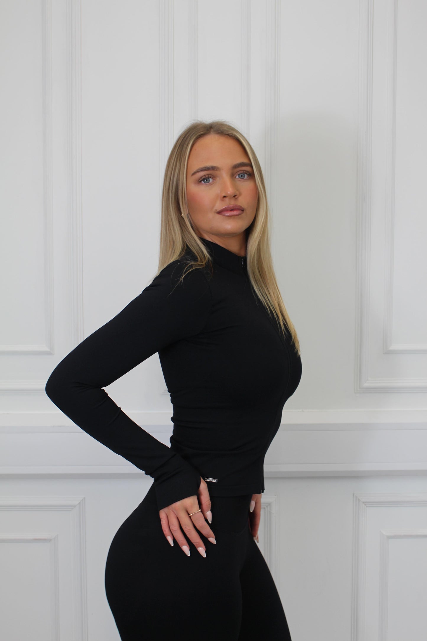 Woman modeling The Empower Edge Collection - Halter Bra, highlighting its stretch fit and luxury comfort, ideal for workouts. Model wears size small.