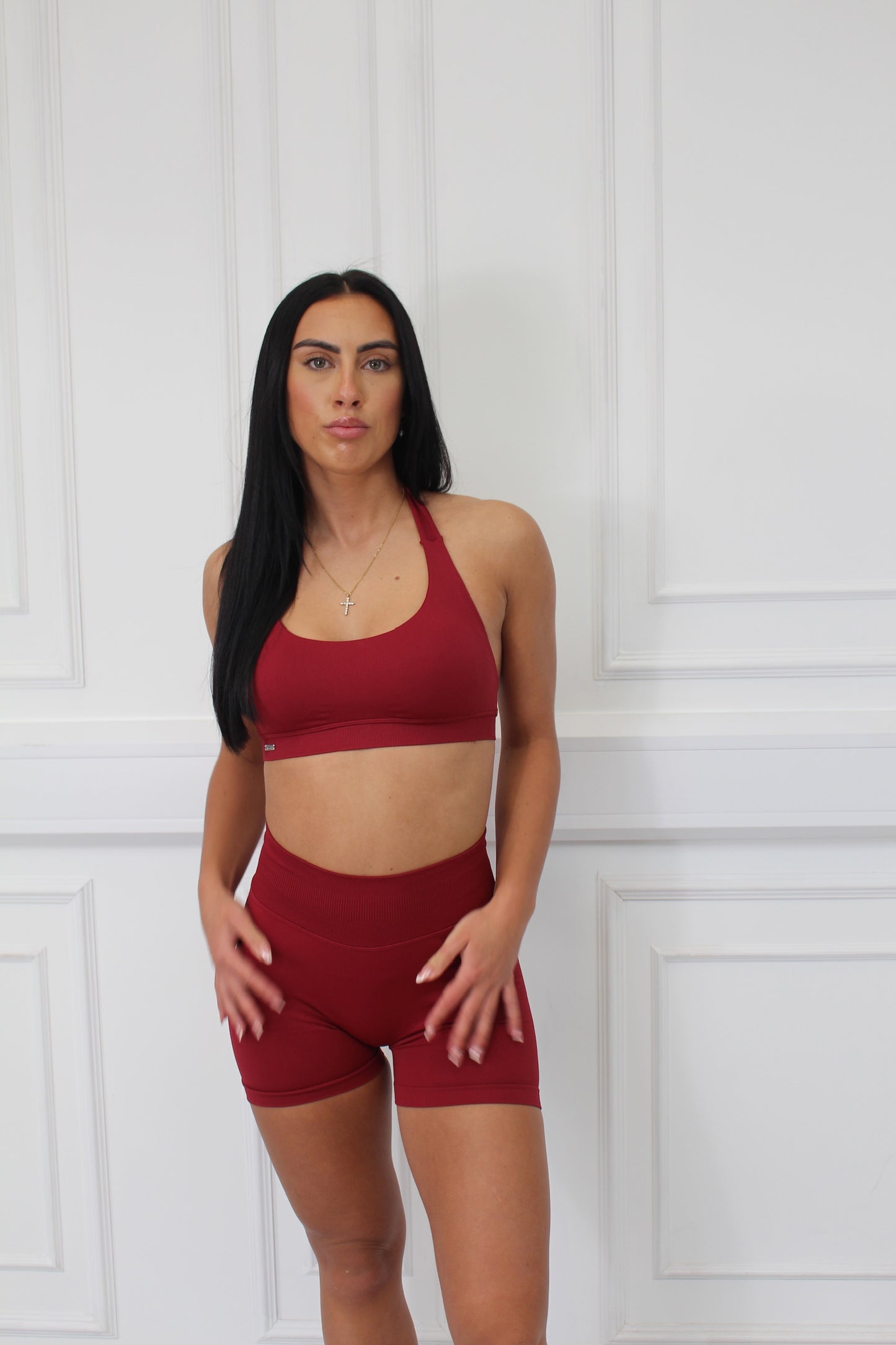 Empower Edge Collection Scrunch Bum Gym Shorts; woman modeling red sportswear, showcasing high-waisted, scrunch bum design with flattering fit and durable fabric.