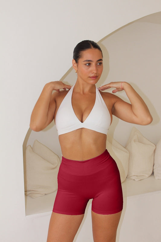 Young woman in The Ilume Collection Scrunch Bum Gym Shorts, showcasing a flattering fit, high-waisted design, and supportive style during a stretch.