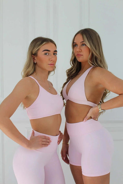 Two women in pink activewear, one in The Ilume Collection Scrunch Bum Gym Leggings, showcasing a flattering design for gym workouts.