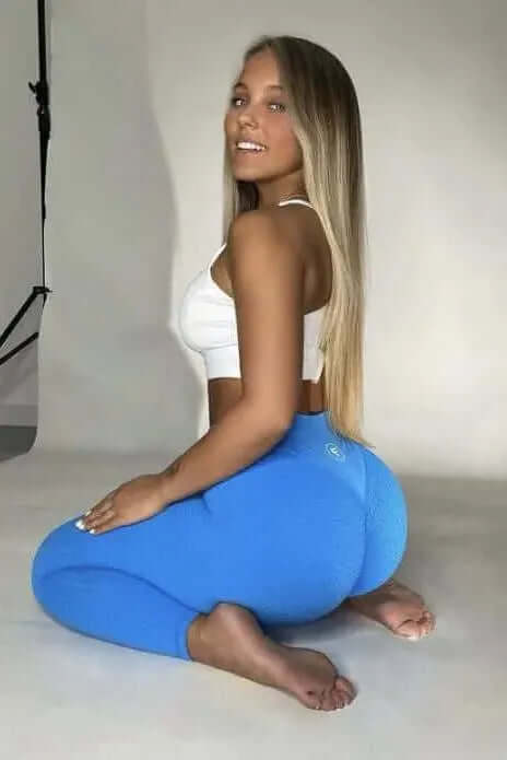 A young woman models the Nova Honeycomb Scrunch Collection - Scrunch Bum Gym Leggings, showcasing their textured design and flattering fit in a studio setting.