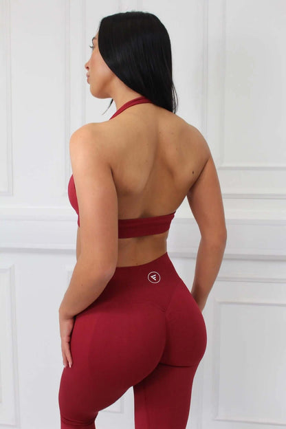 Young woman in deep-red The Empower Edge Collection - Scrunch Bum Gym Leggings, showcasing flattering fit and design, highlighting curve-enhancing, ruched style.