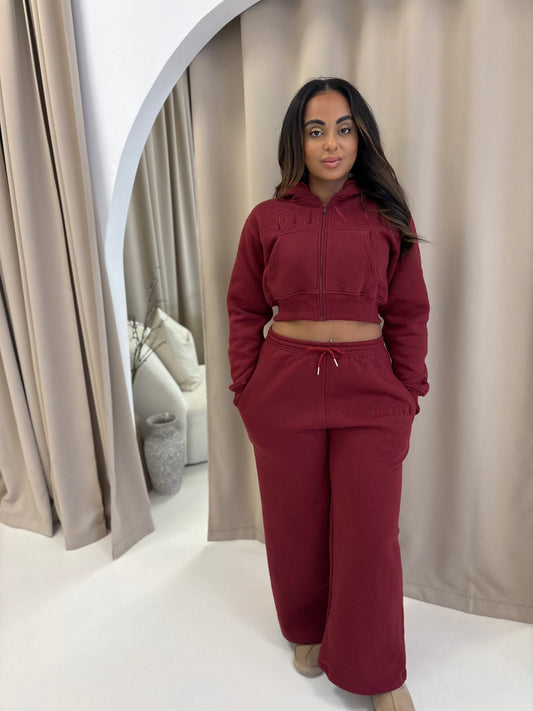 Woman models Elena Lounge Fit Matching Tracksuit Jacket, showcasing its cozy fleece lining and relaxed fit, ideal for stylish comfort.