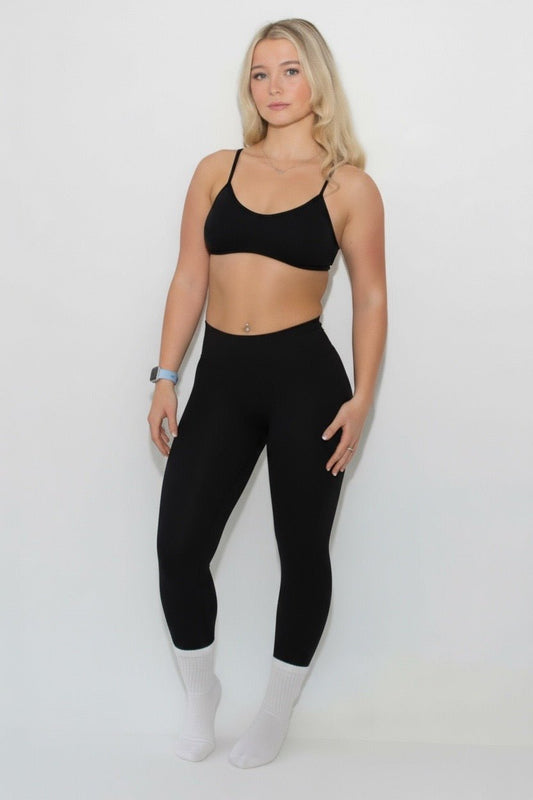A young woman models The Eclipse Collection - Scrunch Bum Gym Leggings, highlighting their flattering silhouette and comfortable high-waisted design, ideal for activewear.