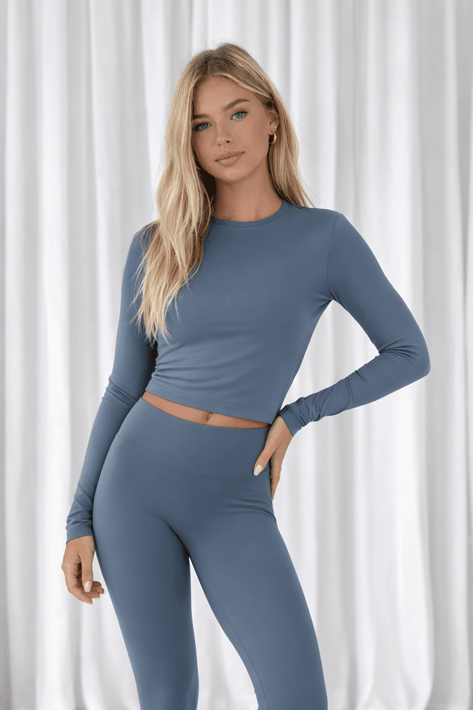 Young woman models the Elena Soft Core Collection's Long Sleeved Everyday Gym T-Shirt, showcasing its form-fitting design and comfort features for active wear.